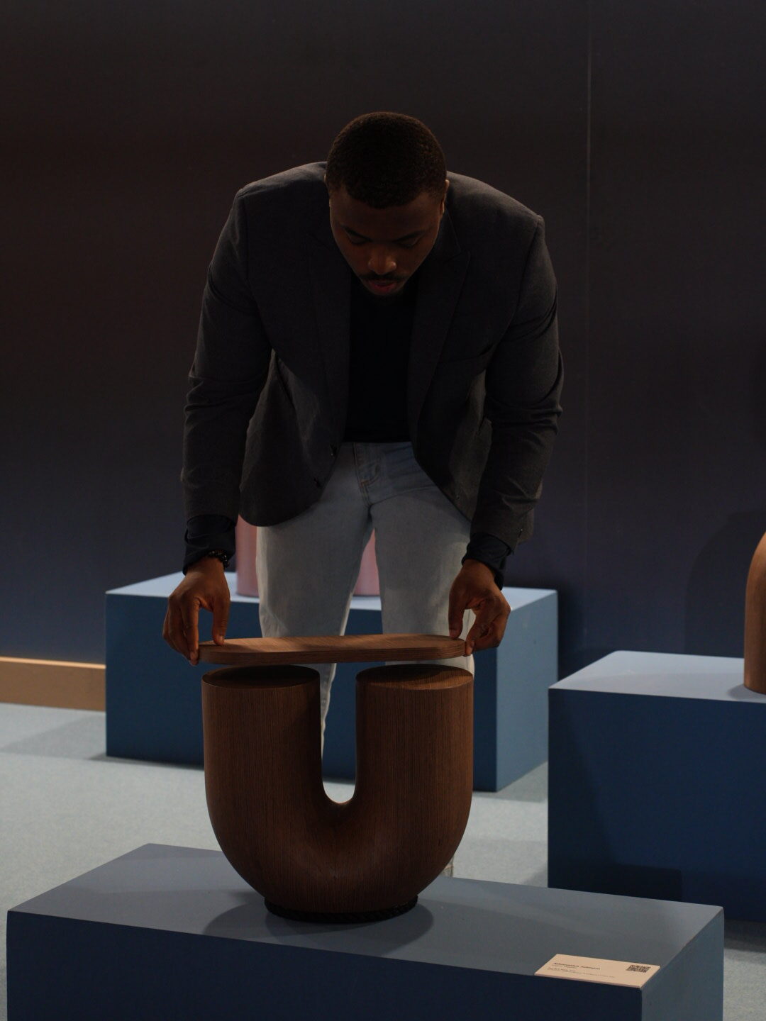 Examining the Apo Stool at an exhibition